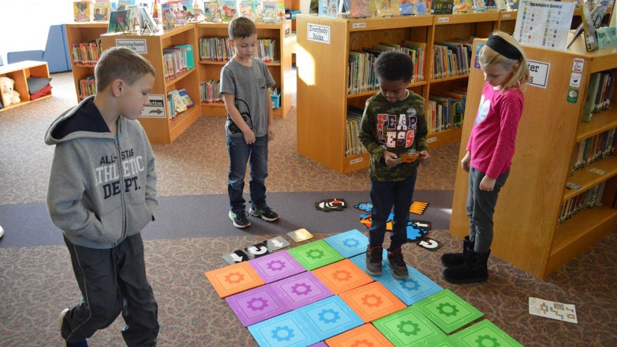 kids coding on floor tiles