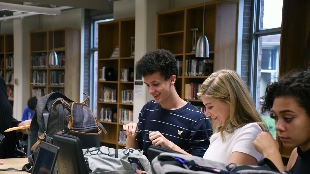 Students work on laptops in the media center