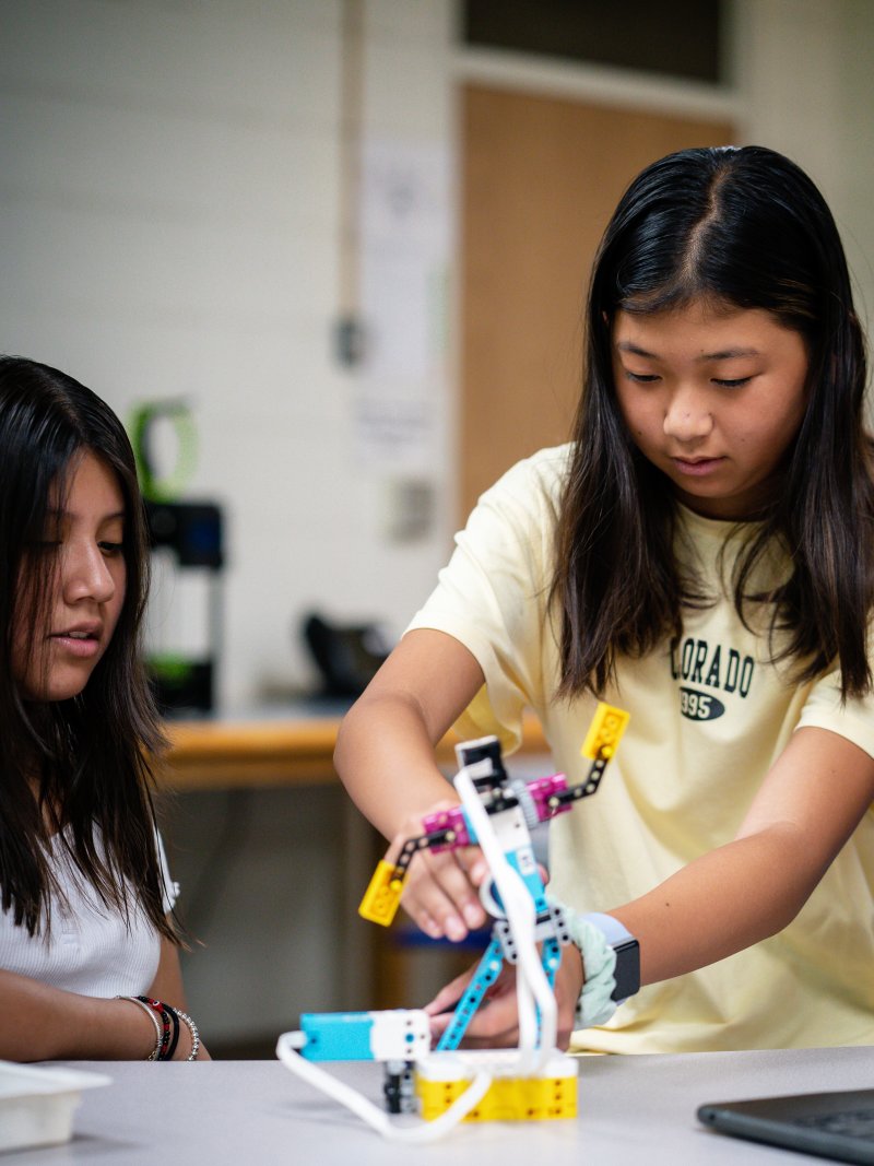 Middle school students working on a robot