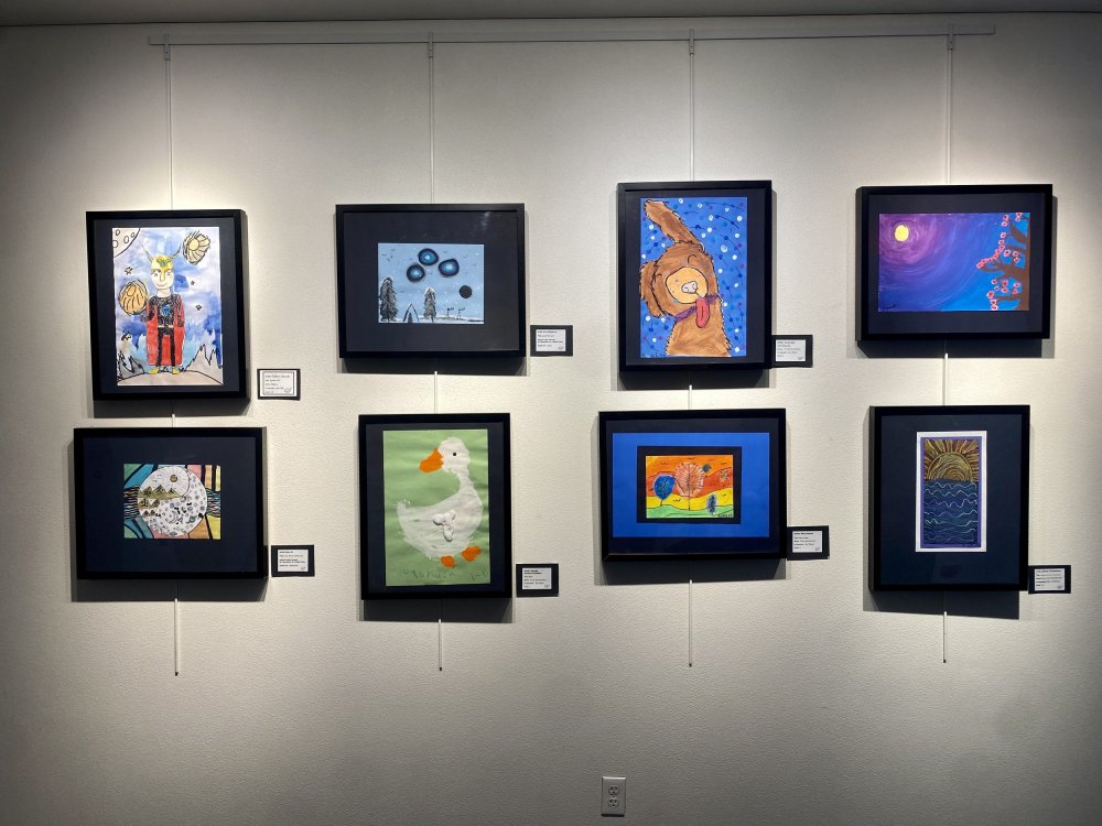 Photo of framed art on display at the Art Show
