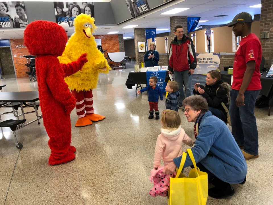 Elmo and Big Bird greet students and families