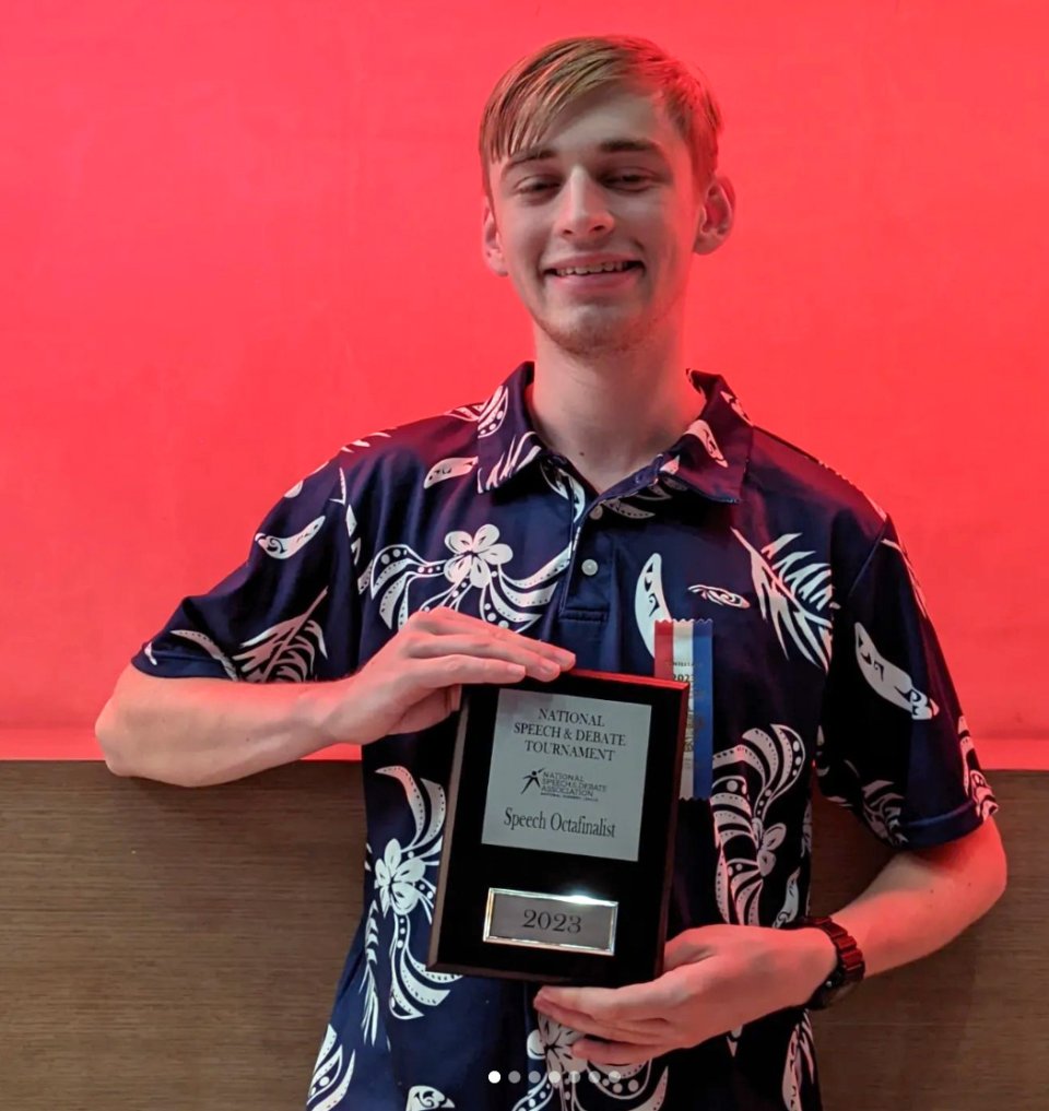 Student holding award plaque