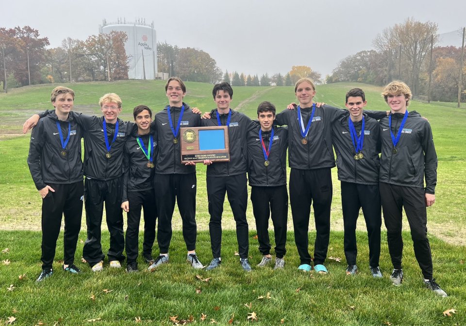 Nine boys cross country athletes holding section championship plaque