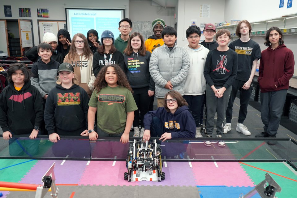 middle school students with their robot